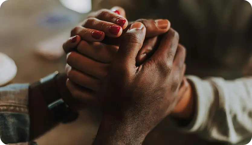 Supportive hands offering comfort for mental health at Willow Behavioral Health.