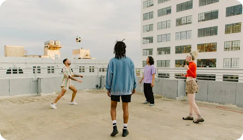 Young adults playing soccer on a rooftop, emphasizing connection in Willow Behavioral Health's outpatient addiction treatment.