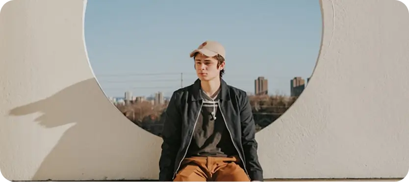 Young person sitting outdoors, symbolizing hope and support for dual diagnosis treatment at Willow in Madison.