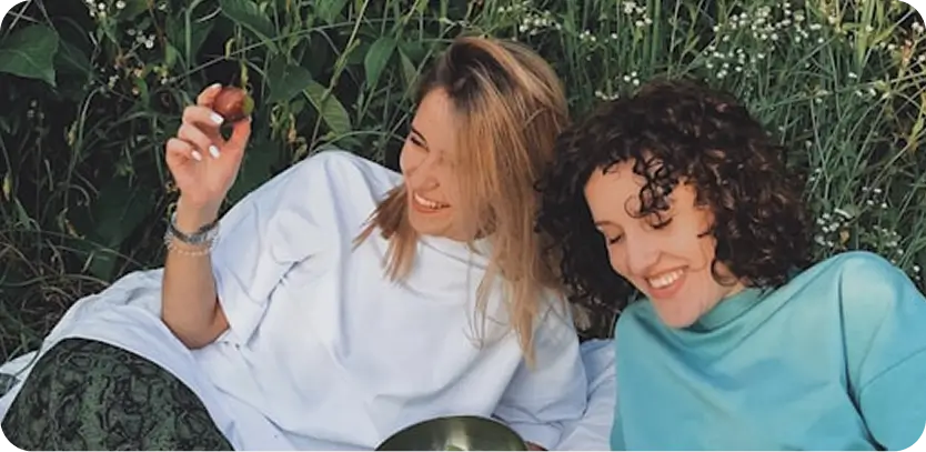 Supportive friends enjoying a relaxed moment in nature, symbolizing compassionate recovery at Willow BH in Madison.