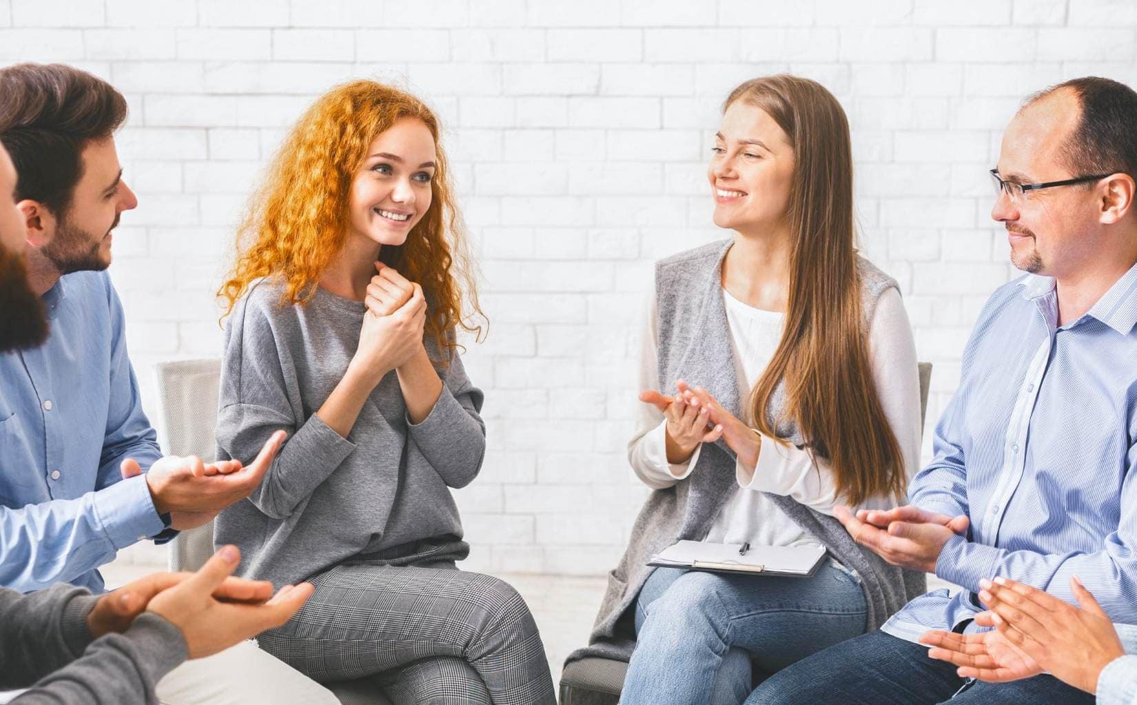 Smiling clients during group therapy at IOP in Madison, WI.