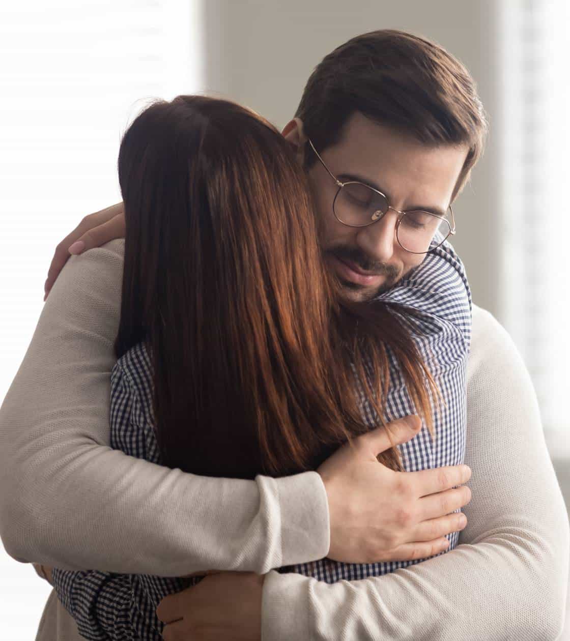Man comforting loved one during family therapy in Madison, WI.