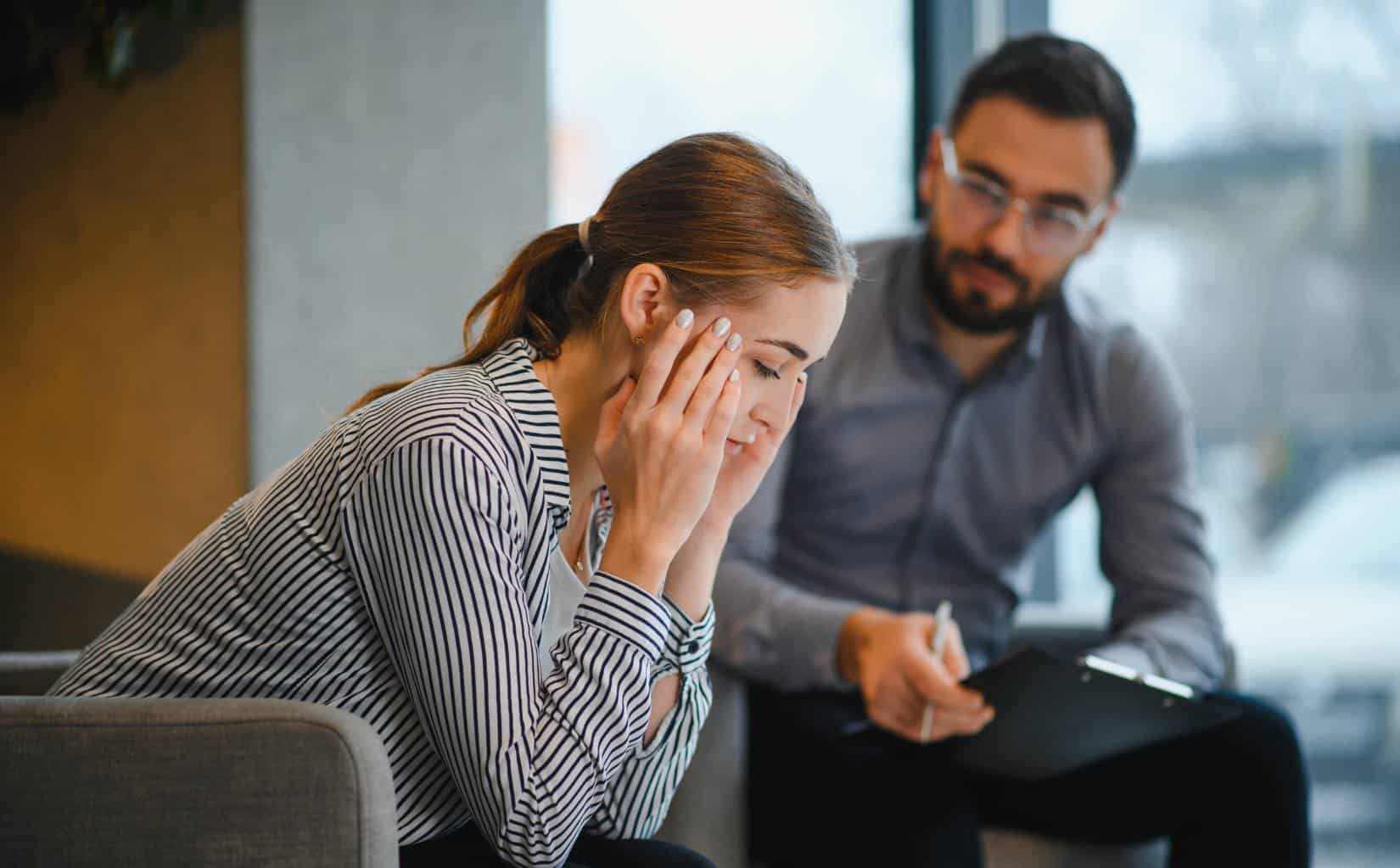 Woman opening up to a therapist during PTSD treatment in Madison, WI.