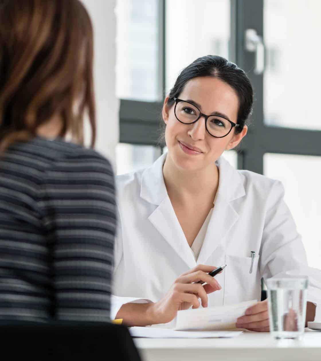 Doctor listening to a client during a consultation for medication assisted treatment in Madison, WI.
