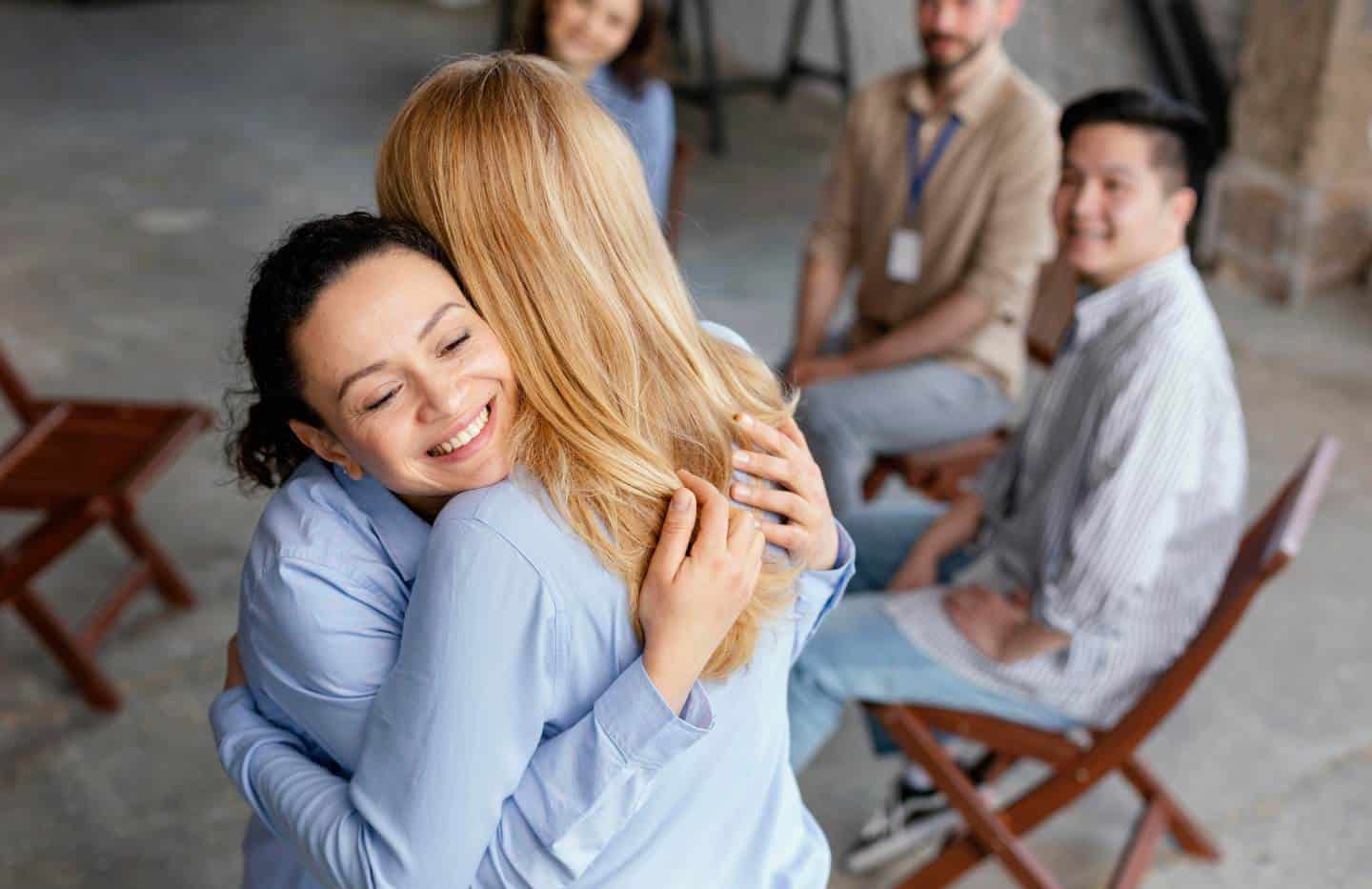 Woman hugging a peer during rehab for professionals in Madison, WI.