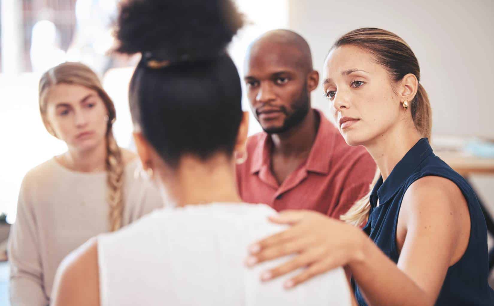 Group participants showing support during cocaine addiction treatment in Madison, WI.