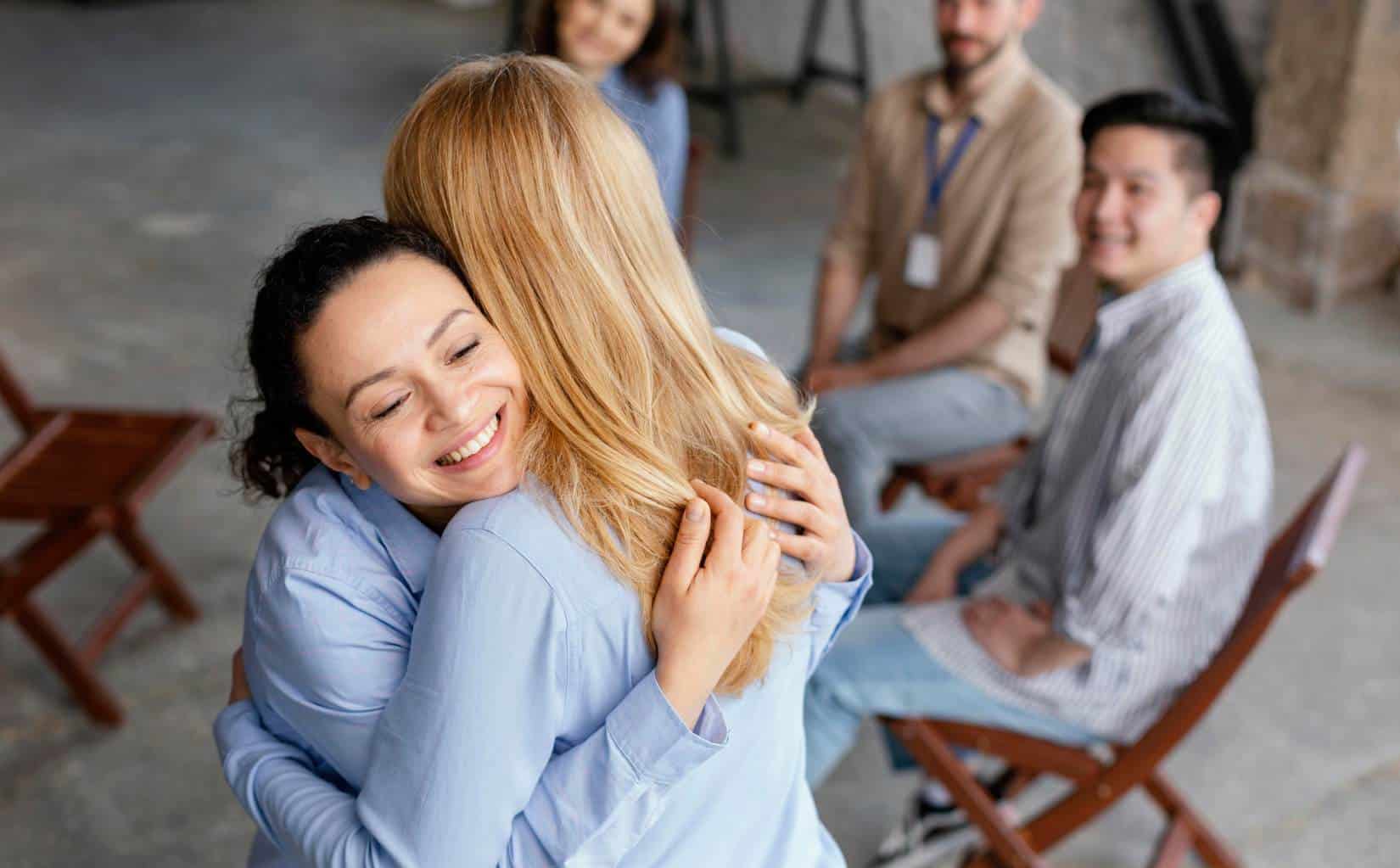 Two group members sharing a hug during marijuana addiction treatment in Madison, WI.