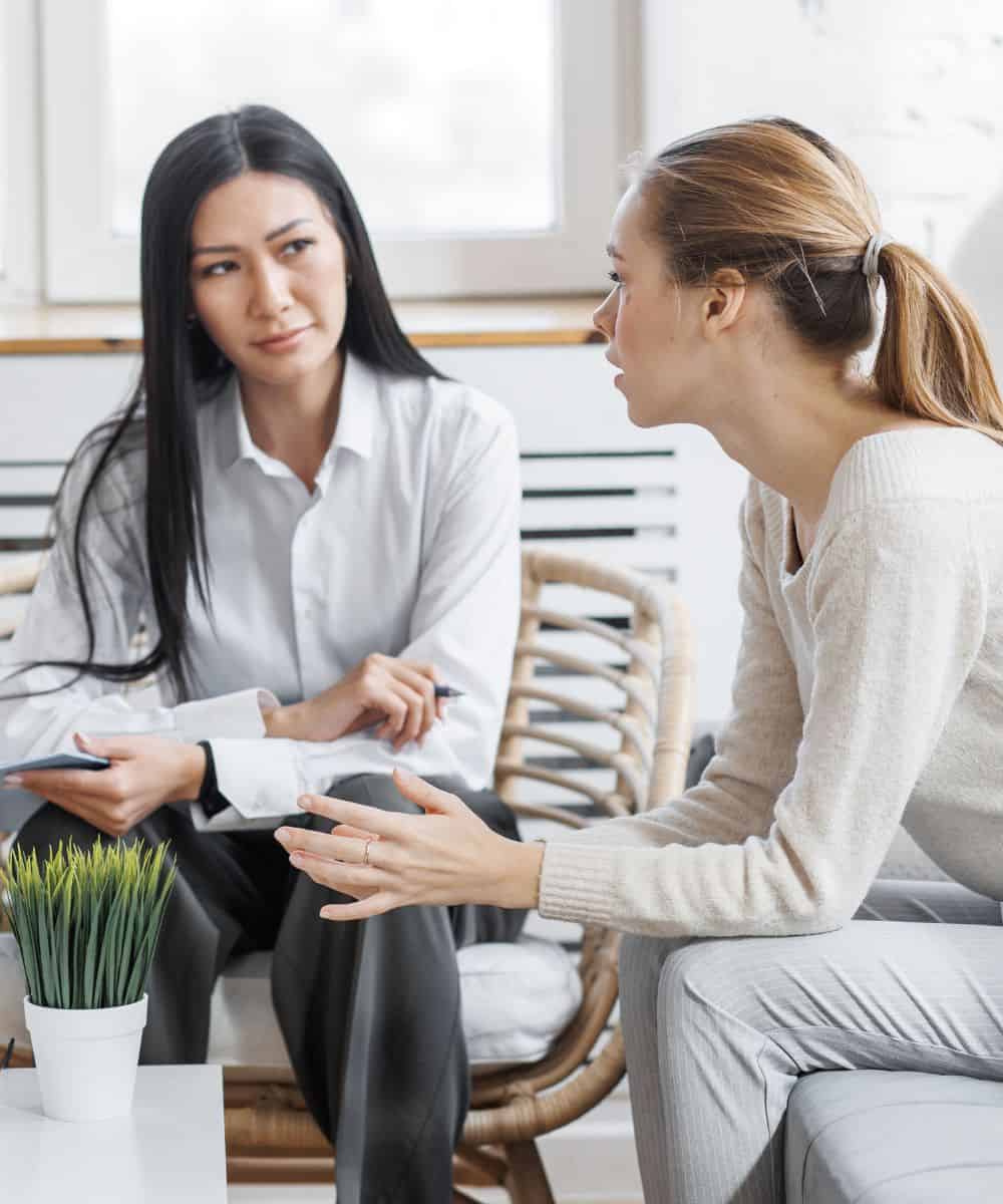 Woman speaking with a therapist during behavioral health treatment for students in Madison, WI.