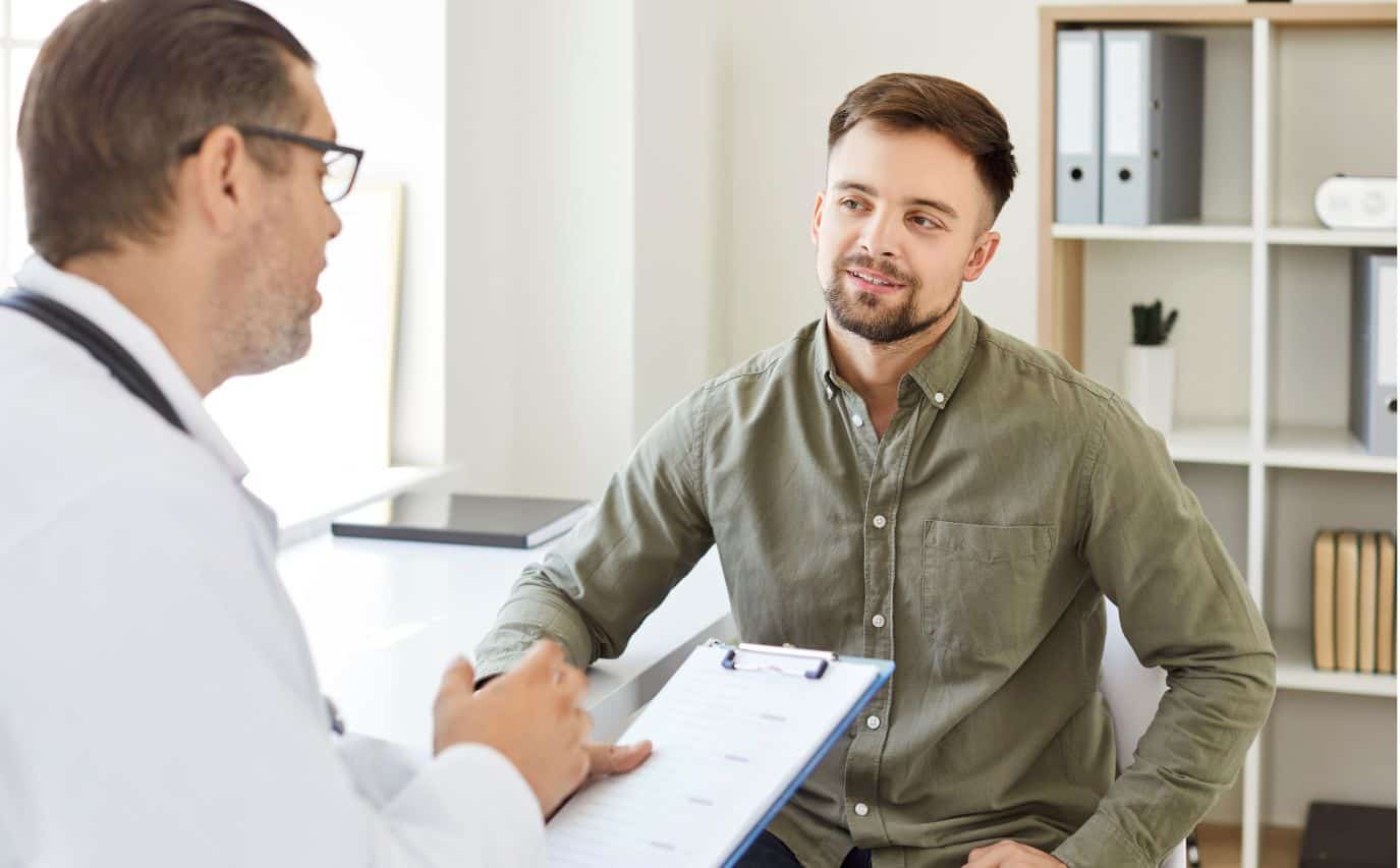 Man discussing medications with his doctor for medication management in Madison, WI.