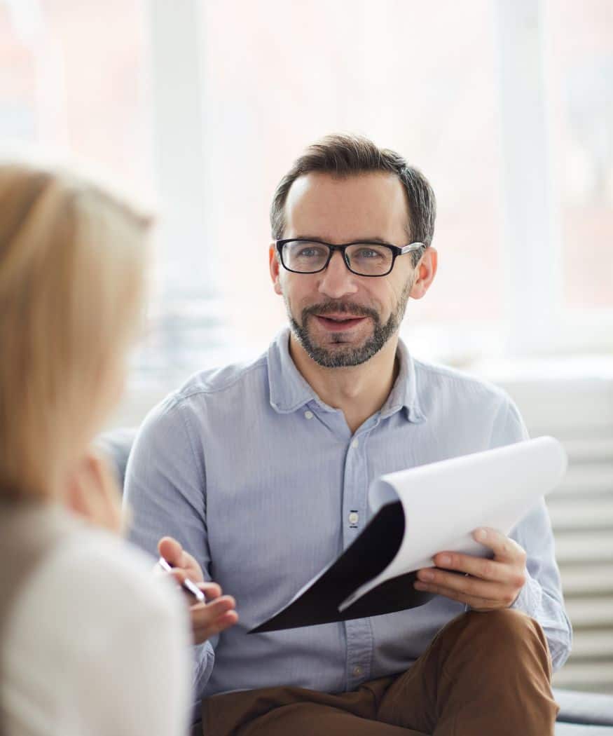 Professional reviewing a client’s needs during an assessment for medication management in Madison, WI.